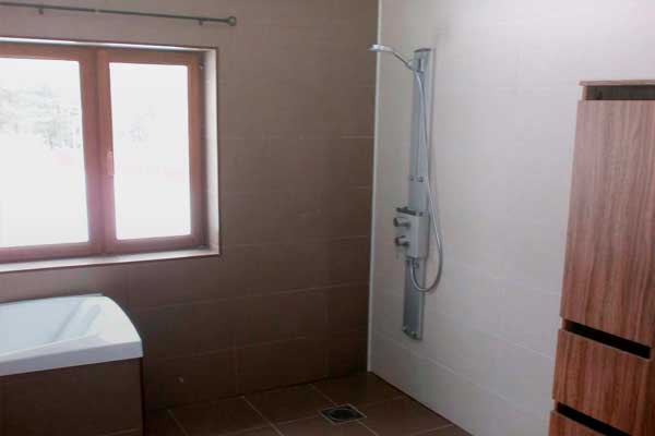 Tile work, door frame installation, and ceiling patching in the bathroom